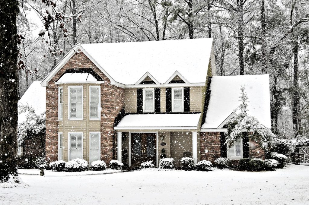 snow covered home with replacement windows