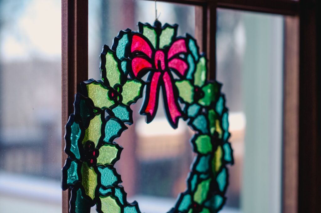 stained glass holiday wreath decor in window