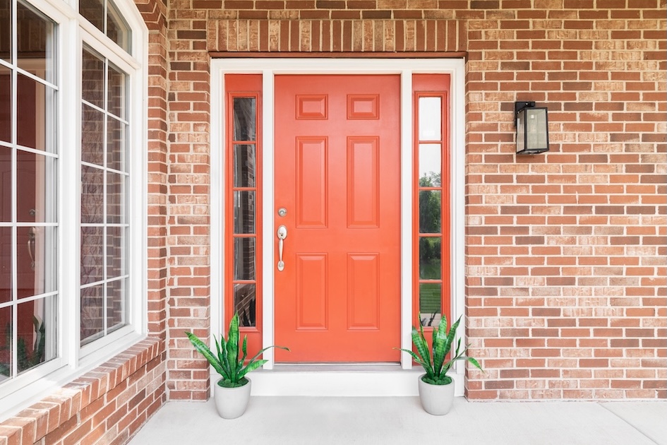 red front door on brick home
